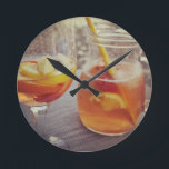 Relógio Redondo Sangria and Sunshine<br><div class="desc">This image shows a refreshing glass and pitcher of citrus sangria, perfect for a warm day. The fresh slices of lemon and orange add bright colour and hint of natural sweetness. One glass sits ready to enjoy while sangria is being poured from a small glass pitcher beside it, perfect for...</div>