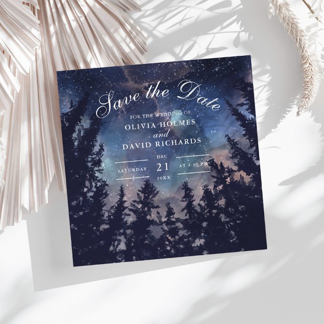 Reserve A Data Floresta Noturna Estrelada Celestial Salvar a Data (Starry Night Forest Save The Date Card on a white boho table with dry palm leaf.)