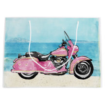 Motocicleta rosa na praia