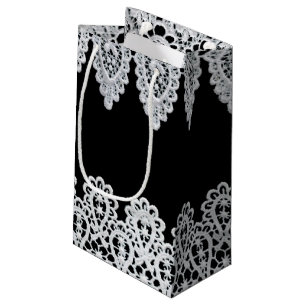 Sacola Para Presentes Pequena O laço branco forma uma beira delicada contra o