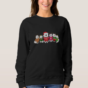 Samoyeds com suéteres de Natal
