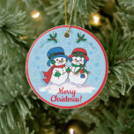 Sr. & Sra. Frosty O Ornamento Cerâmico de Snowman<br><div class="desc">Personalize este Enfeites de natal único de "um tipo"! Sr. & Sra. Frosty O boneco de neve Vestindo seus chapéus de Natal, Os Malgas de Orelha e Escarpões estão pegando um Rolo de Natal Mágico através de uma "Terra das Noites de Inverno"! Pintura de arte original do artista Kerry Miller....</div>