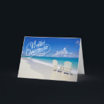 Sunny Beach Com 2 Cadeiras De Cartão De Natal<br><div class="desc">Desejos quentes de Natal da praia! Uma bela praia ensolarada com ondas do oceano caindo ao longo da areia. Há duas cadeiras brancas de praia,  de costas,  voltadas para o oceano. Na frente lê-se "Olá Natal". Veja os vários design e estilos em nossa loja.</div>