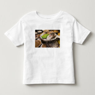 T-shirts Biscoitos do Natal na exposição em uma Nova Iorq