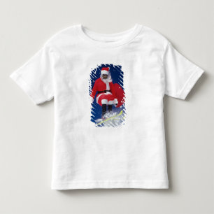 T-shirts Papai Noel no salto de esquis fora de um cornice