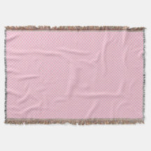 Um cobertor decorativo rosa com um padrão geométri